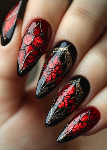 Intricate black and red almond-shaped nail art with gold accents in gothic design.