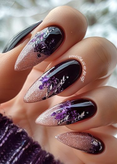 Elegant stiletto nails with black polish, pink glitter gradient, and floral designs.