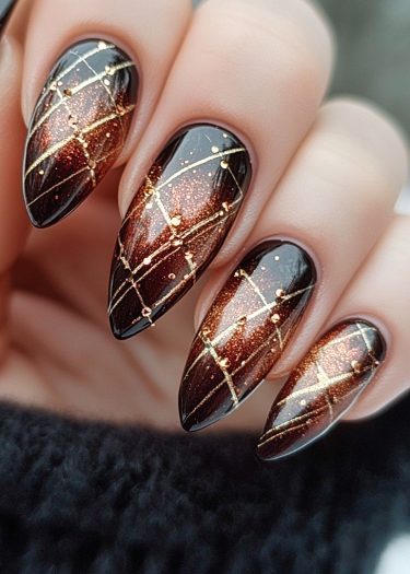 Stunning stiletto nail art featuring a gradient design with gold accents and intricate patterns.