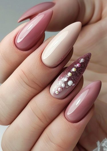 Sophisticated pink stiletto nails feature glossy finishes and intricate glitter designs for a stunning look.