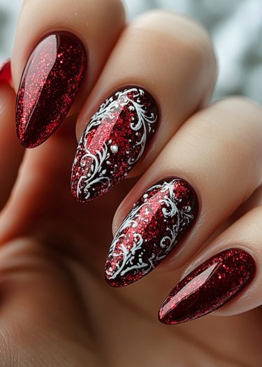 Elegant stiletto nails in glittery red with intricate white floral designs and 3D beads.