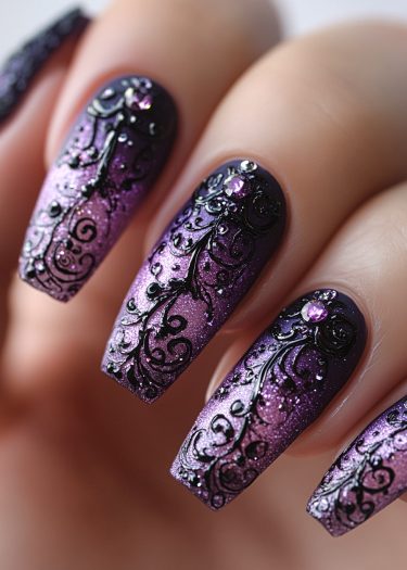 Elegant gradient purple nail art with intricate black designs and sparkling rhinestones.