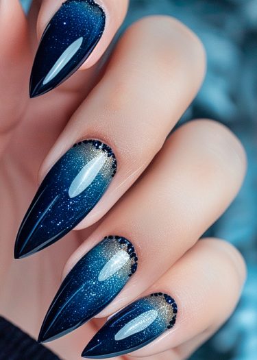 Elegant almond-shaped nails in midnight blue with gold accents and rhinestones for a stunning look.