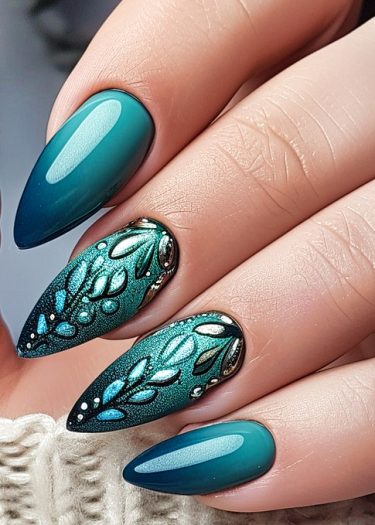 Elegant teal and emerald nail art with intricate leaf designs and glossy finish.