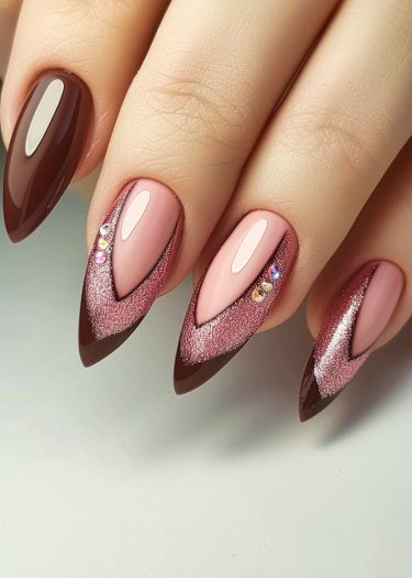 Elegant pink and brown nail art with glitter and rhinestones for a bold, luxurious look.