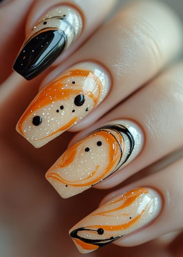 Bold swirl nail art design in black, orange, and shimmering beige with intricate patterns.