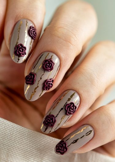 Elegant taupe nail art featuring maroon roses and gold metallic accents for a sophisticated look.