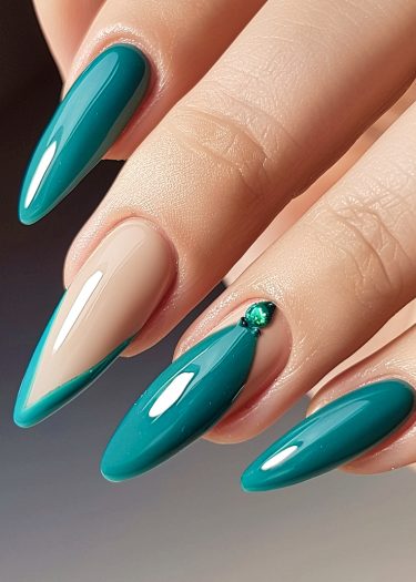 Elegant teal and nude almond-shaped nails with jewel accents, showcasing meticulous manicure artistry.