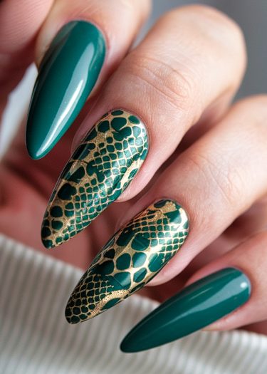 Elegant emerald green almond nails with gold snake scale design for a chic manicure.