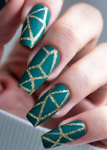 Teal matte nails with intricate gold geometric design for a chic manicure look.