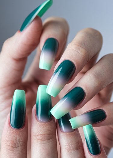 Elegant teal and mint ombre nails in a tapered square design showcase stunning nail artistry.