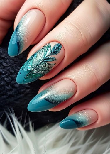 Elegant teal and nude almond nail art with glitter and peacock feather design.