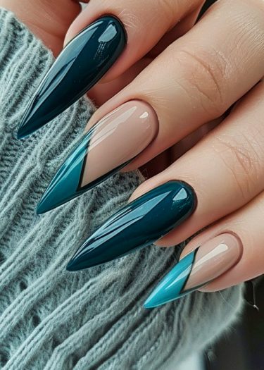 Stylish teal and nude stiletto nails featuring geometric nail art on cozy fabric background.