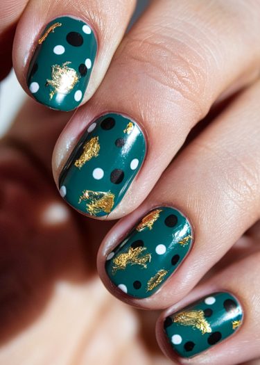 Elegant teal polka dot nail art with gold foil accents for a trendy manicure look.