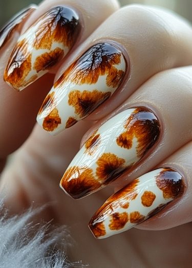 Elegant tortoiseshell nail art with intricate patterns in brown and amber shades.