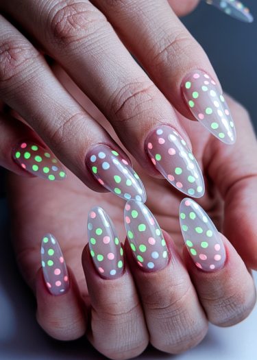 Elegant translucent polka dot nails in vibrant colors create a playful, eye-catching manicure.