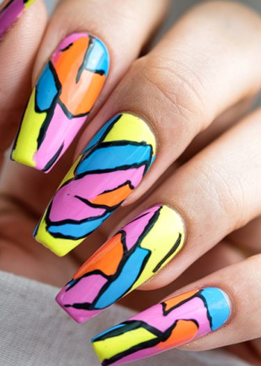 Colorful abstract nail art design with geometric patterns and bold black outlines on long nails.