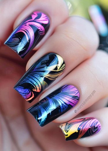 Vibrant abstract nail art design with glossy black base and colorful swirling patterns.