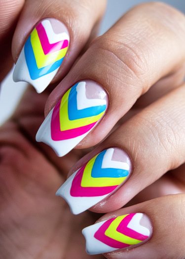 Vibrant chevron nail art featuring bright colors on beautifully manicured nails.