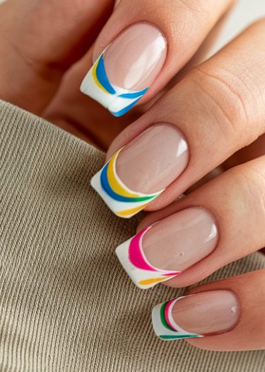 Colorful French tip nails with artistic designs on a well-manicured hand.