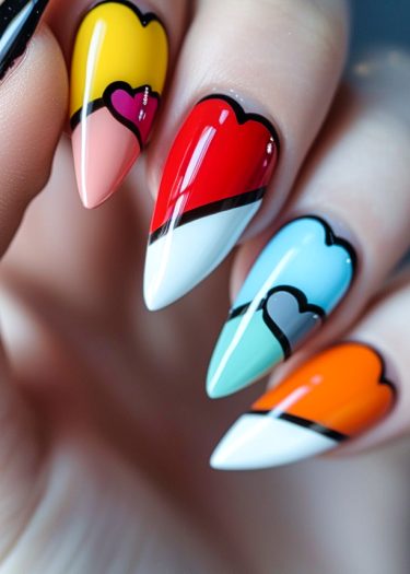 Colorful pop art nail designs with hearts on long, pointed nails create a striking manicure.