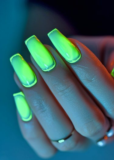 Vibrant neon green square nails shine brilliantly against a dark backdrop, highlighting a flawless manicure.