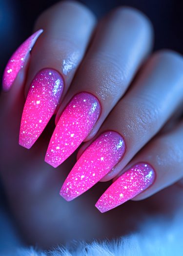 Vibrant pink coffin nails with glitter showcase elegant design and sophisticated nail art.