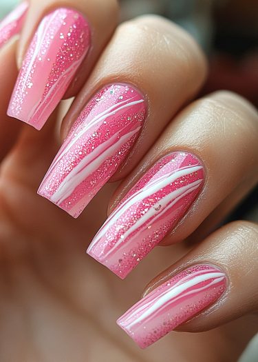 Vibrant pink glitter nails with elegant white lines create a stunning manicure design.