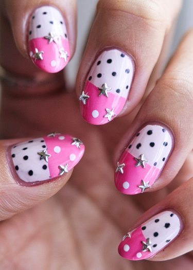 Playful pink and white nail art with polka dots and silver stars for a chic look.