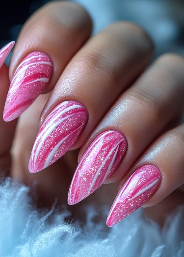 Elegant stiletto nails with vibrant pink marble design and sparkling finish for a stunning look.