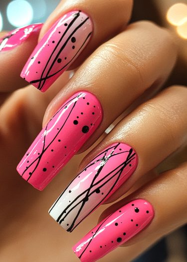 Elaborate pink nail art with black designs and a gradient on the ring finger.