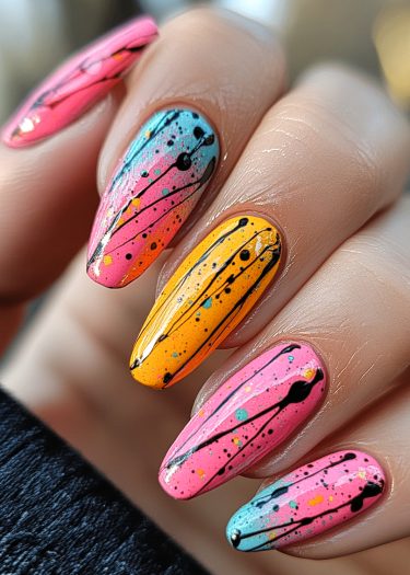 Vibrant splatter nail art with bright colors and abstract designs for a modern look.