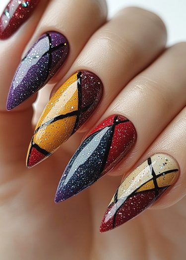 Striking geometric stiletto nail art in vibrant colors with glitter and glossy finish.