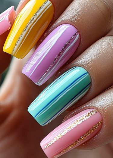 Pastel striped nail art design featuring vibrant colors and glitter accents for elegant manicures.