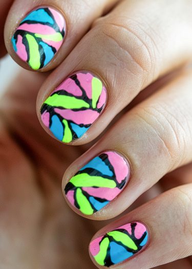 Vibrant nail art featuring swirling neon designs in pink, green, blue, and black.