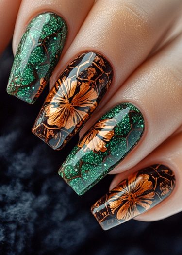 Stunning long green glitter nails with metallic flower designs in copper-orange.