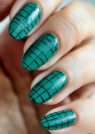 Elegant green almond nails with black grid pattern for bold nail art inspiration.