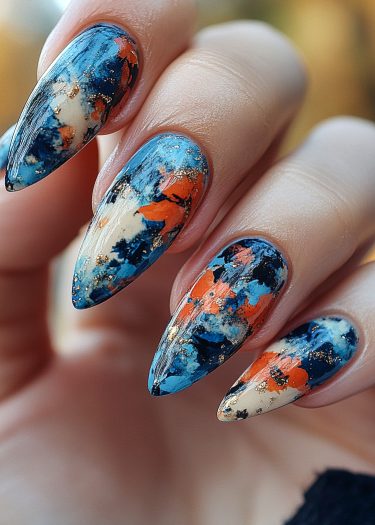 Vibrant watercolor stiletto nails with abstract patterns and gold accents for artistic nail art.