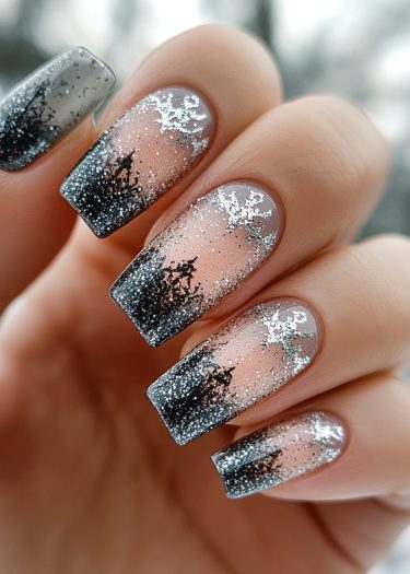 Elegant winter-themed nail art with gradient design, forest silhouettes, and sparkling glitter accents.