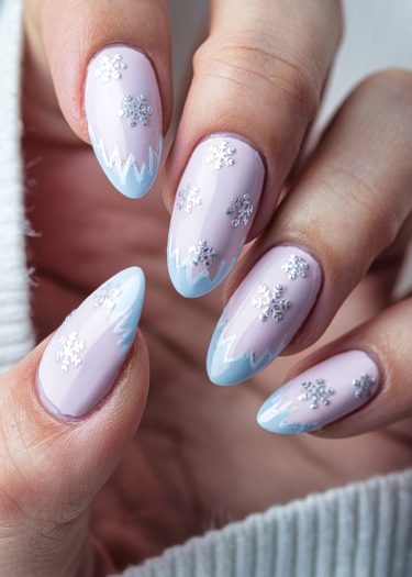 Elegant winter-themed nail art with lavender base and frosty blue zig-zag patterns.