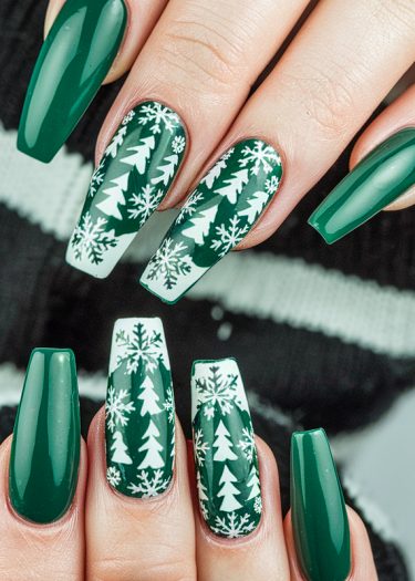 Elegant winter-themed nail art with green and white designs of snowflakes and pine trees.