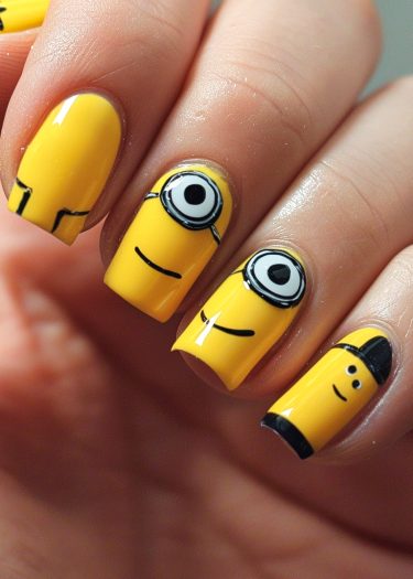 Creative yellow cartoon nail art featuring playful Minion-inspired designs and intricate character details.